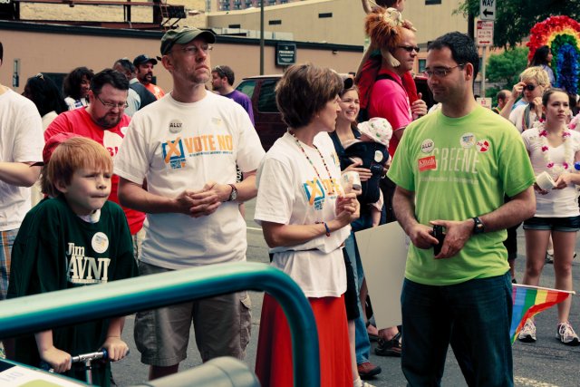 State Auditor Rebecca Otto speaks with Brian Shekleton and Rep. Jim Davnie looks on.